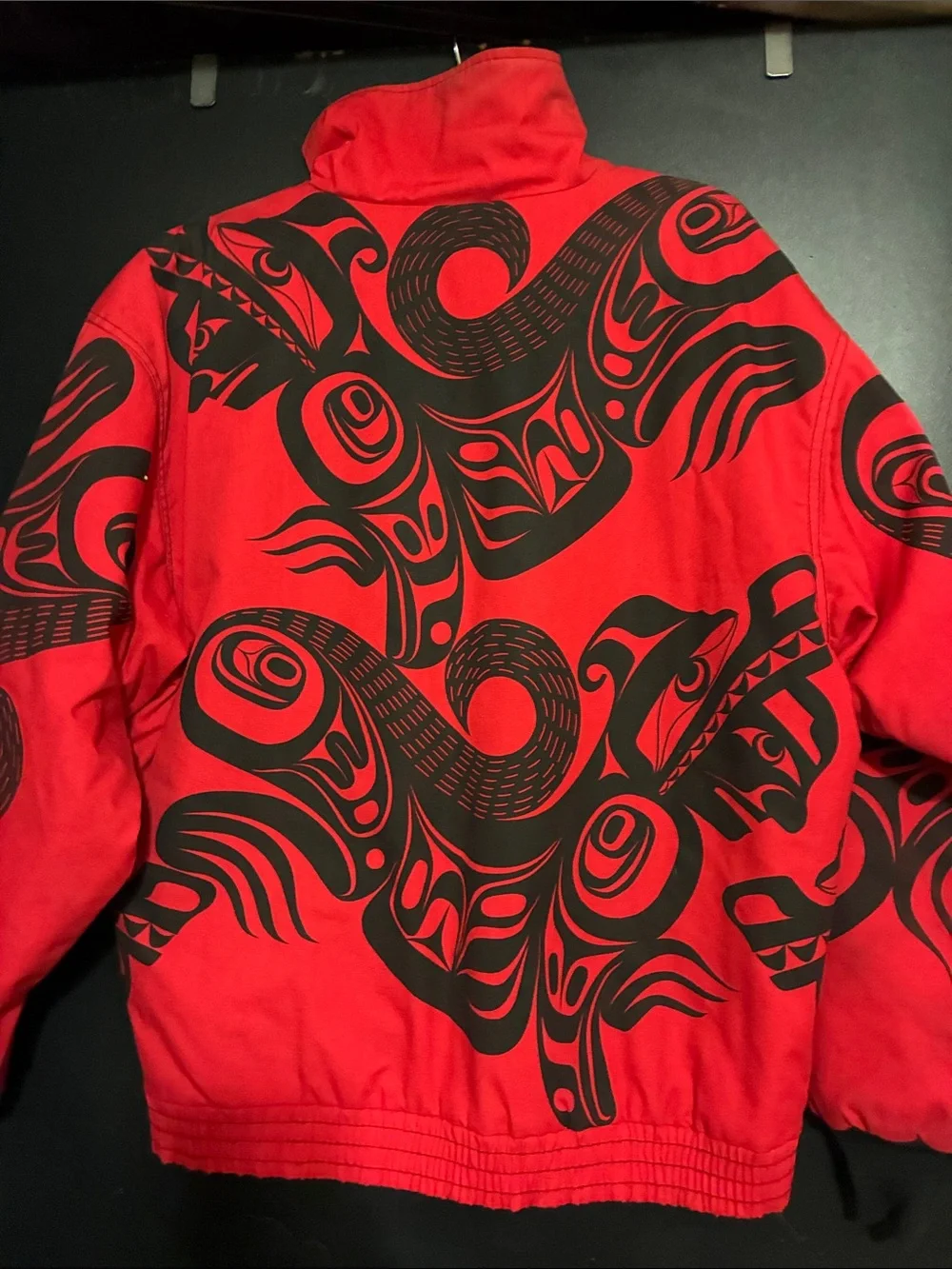 Red Puffer Jacket with Black Graphic Detailing